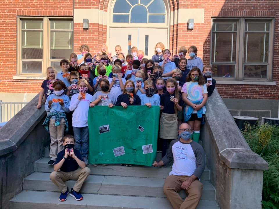 Students of St. Peter Interparish School in Jefferson City show their solidarity with refugees from Afghanistn in this Oct. 26 photo. Students and staff collected and participated in donating over $1,200 in gift cards for Catholic Charities Refugee Services to help refugees.